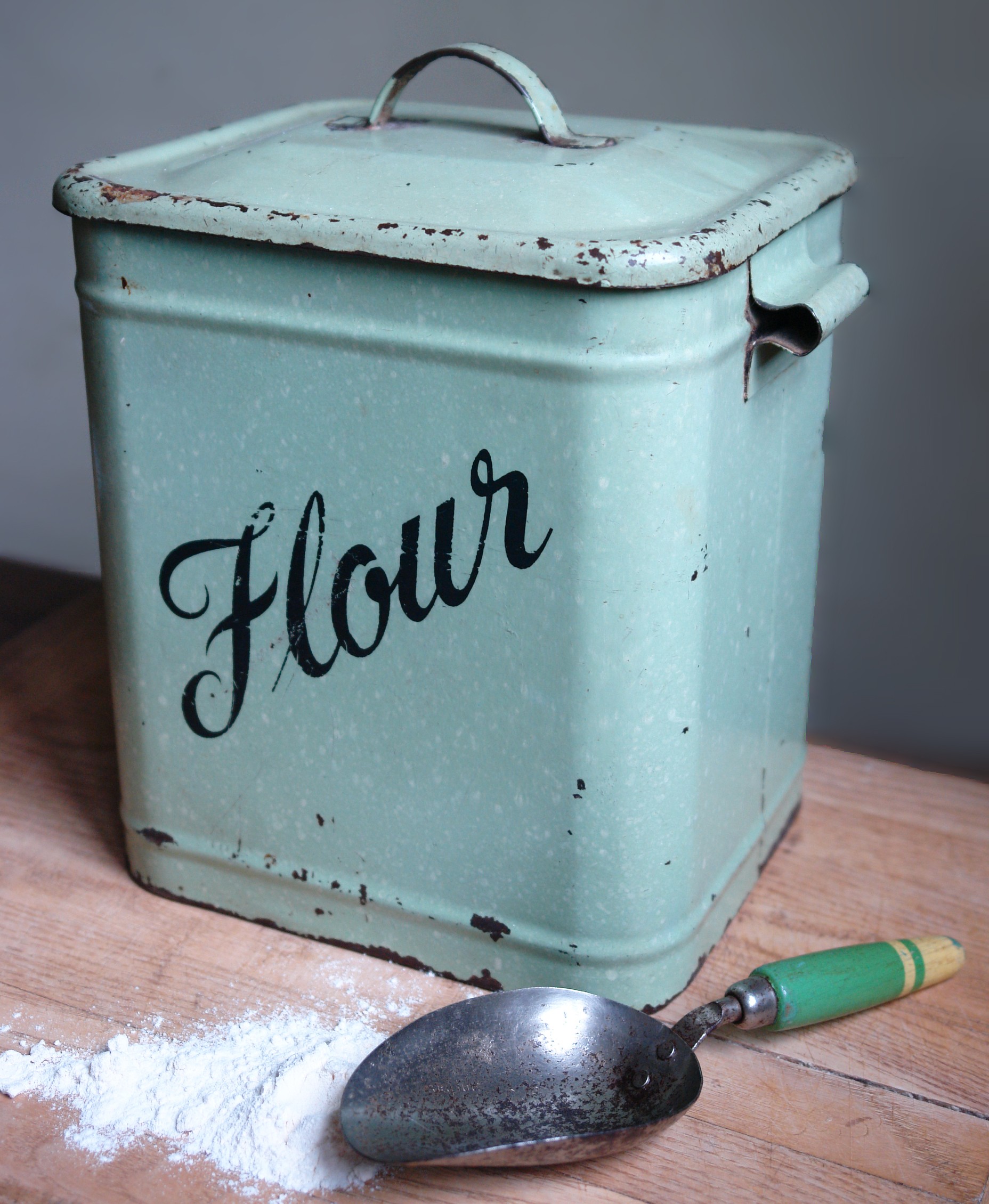 Small vintage green enamel flour container with green painted wooden