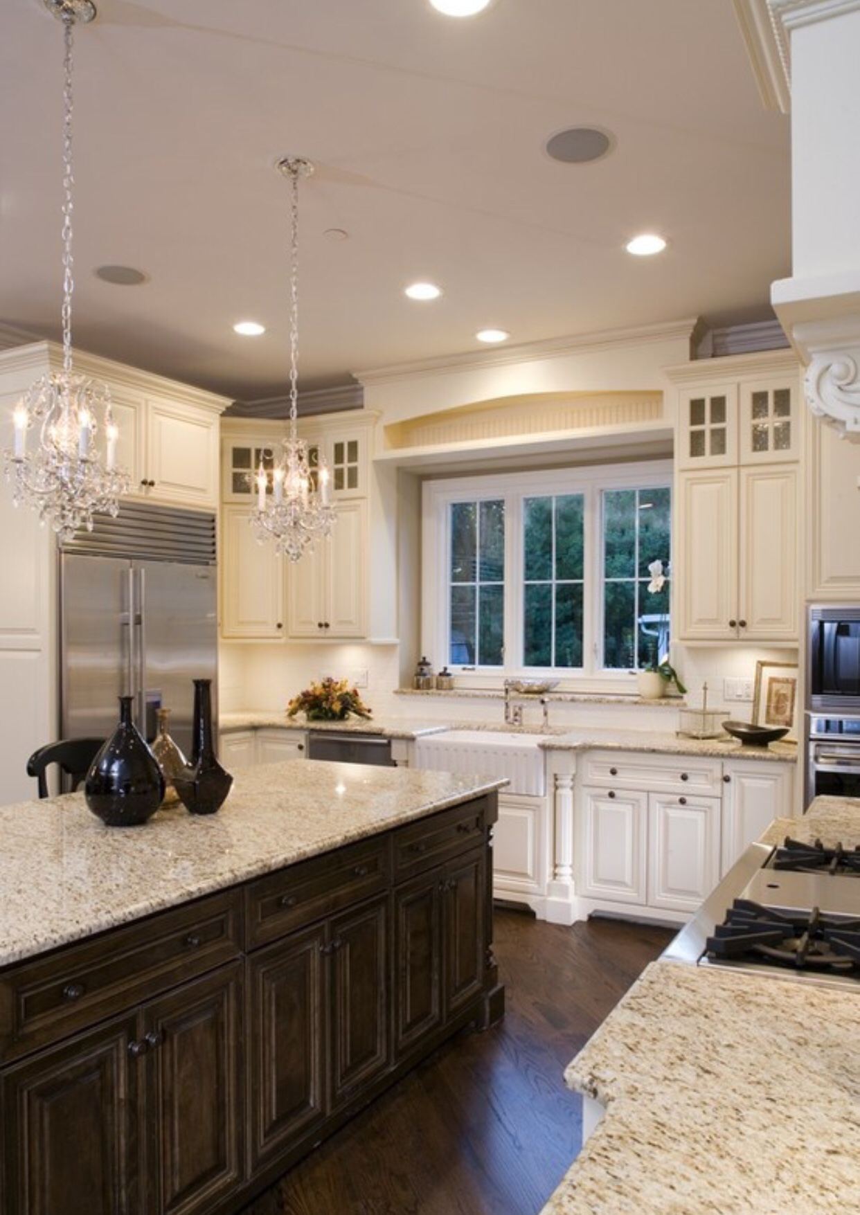 Kitchen with mix of dark wood and cream cabinets could