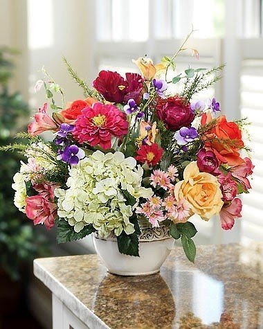 Vibrant tones of salmon raspberry cream green and purple help