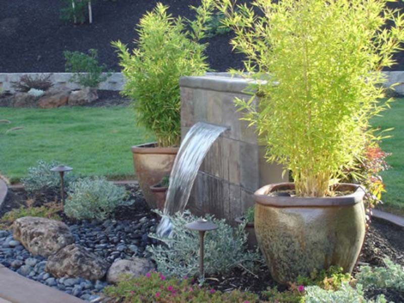 The pots of bamboo on either side of the water
