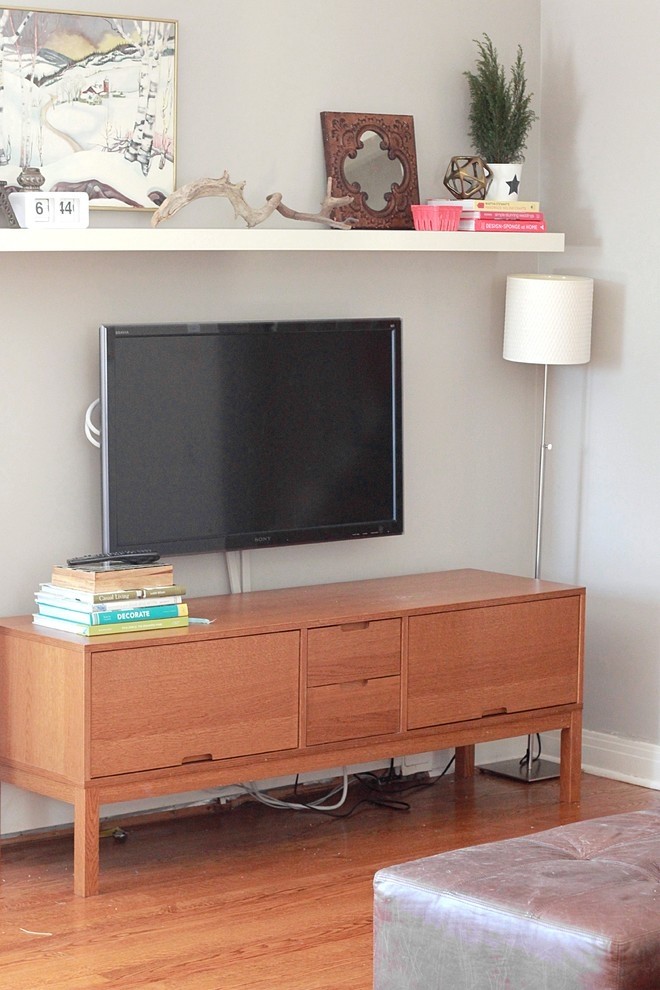 Shelf above tv books art frames driftwood