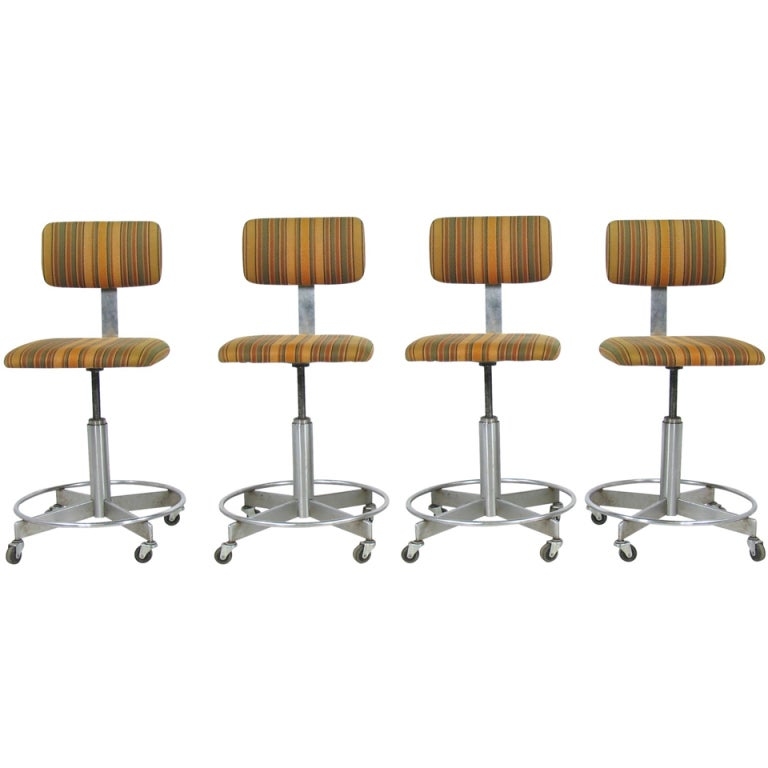 Set of four adjustable mid century industrial stools chairs on