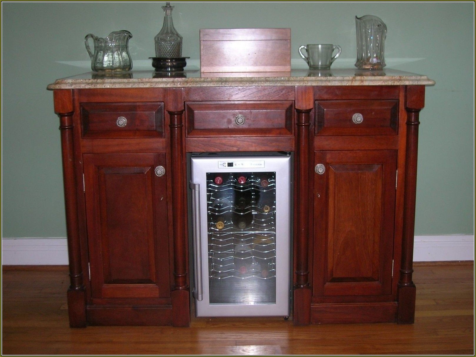 Wine bar with refrigerator and hardwood floors