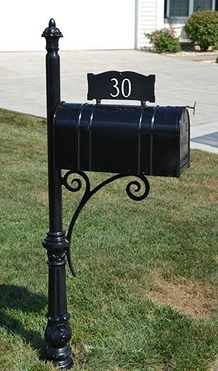 Heavy iron mailbox post with the contemporary bracket standing in