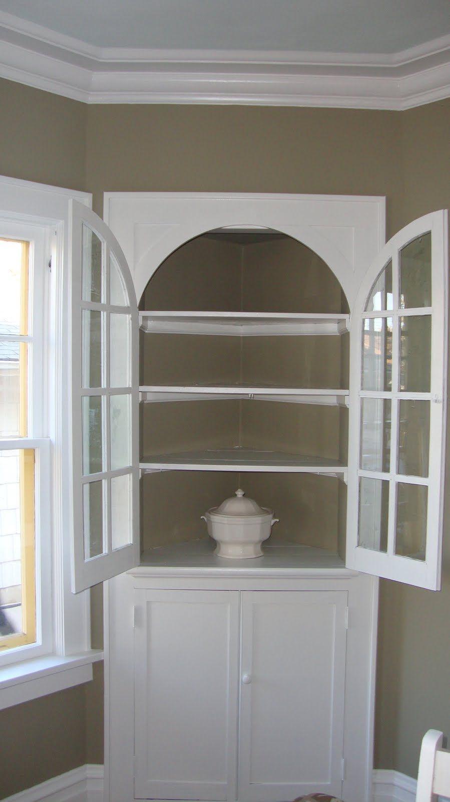 The corner curio cabinet stands out now that it is