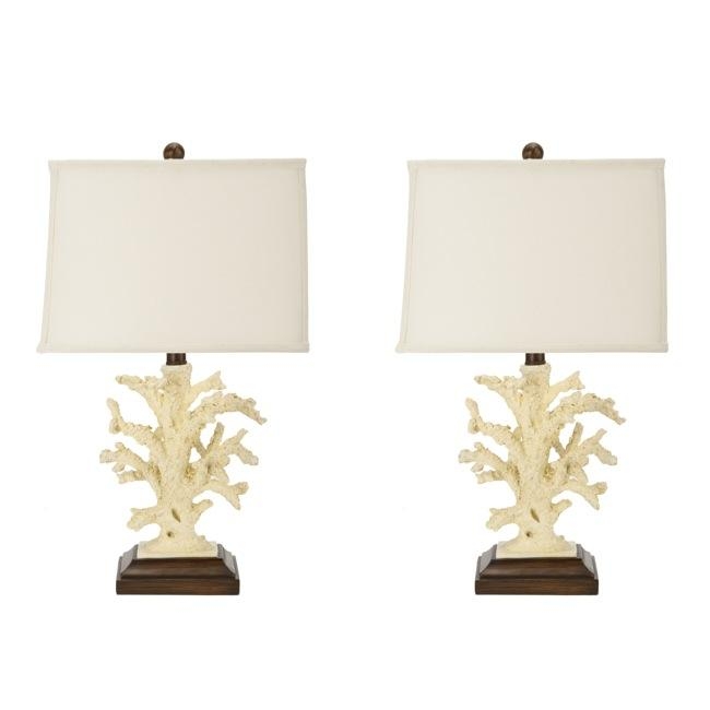 Ceramic beach coral adorns the wood base of this set