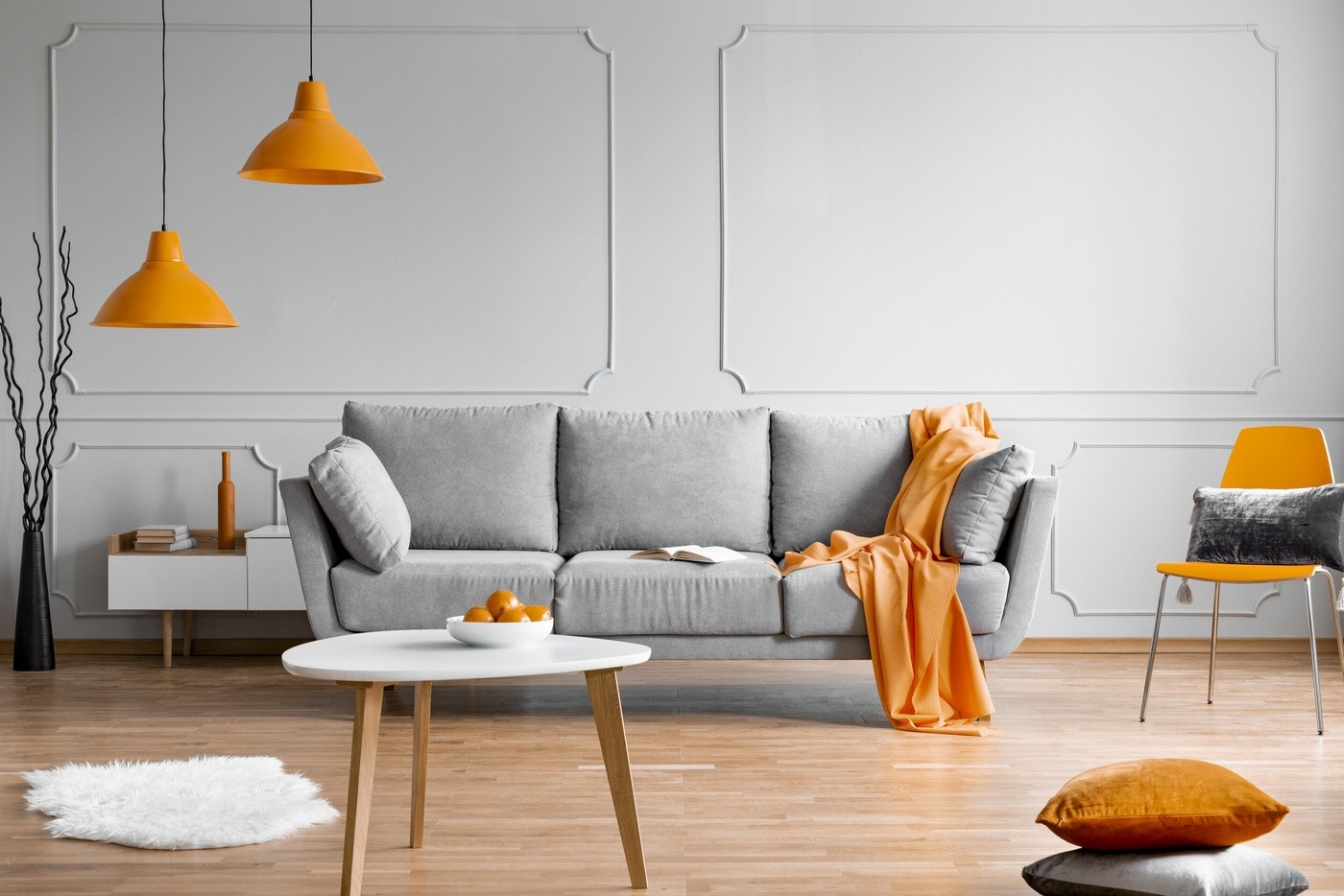 Orange Lamp Above Grey Sofa