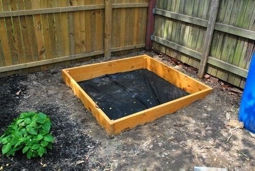 Wooden sandbox with cover