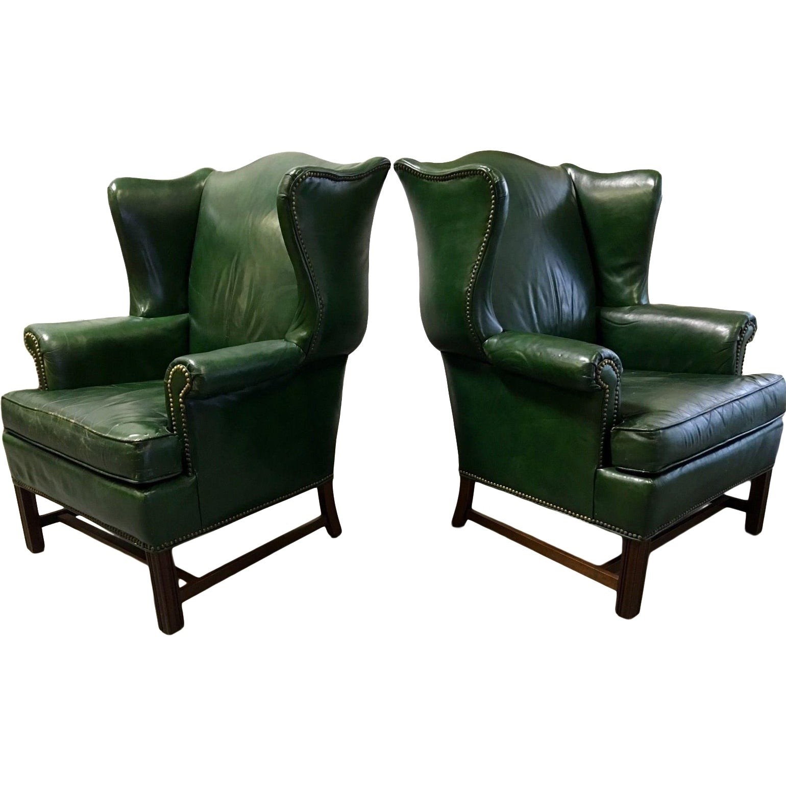 Pair of vintage green leather wingback chairs
