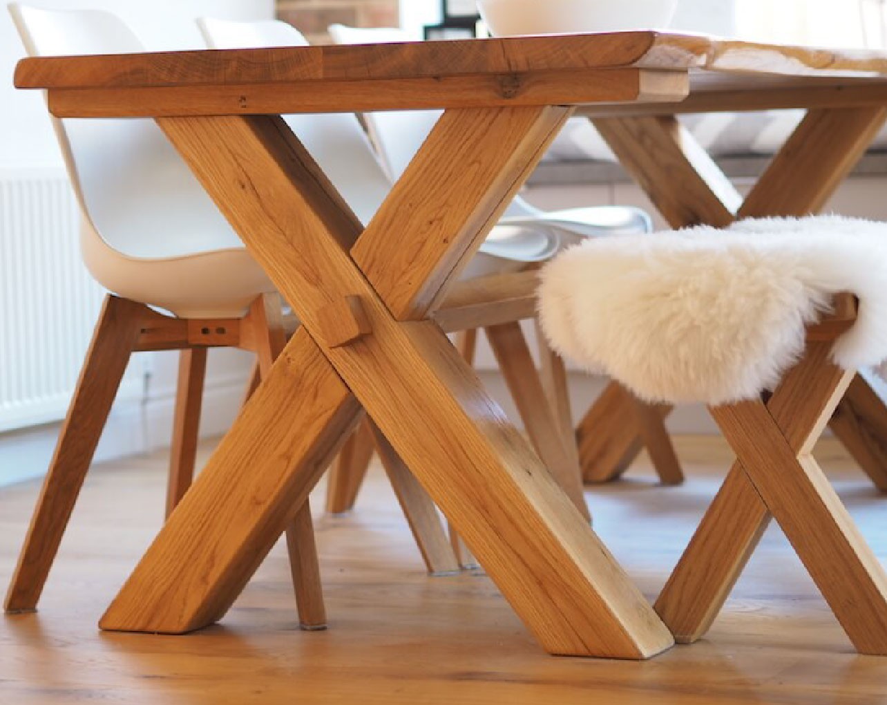 Cross leg solid oak dining table handmade in the uk