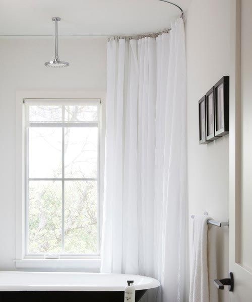 Oval shower curtain track rod installed with clawfoot tub