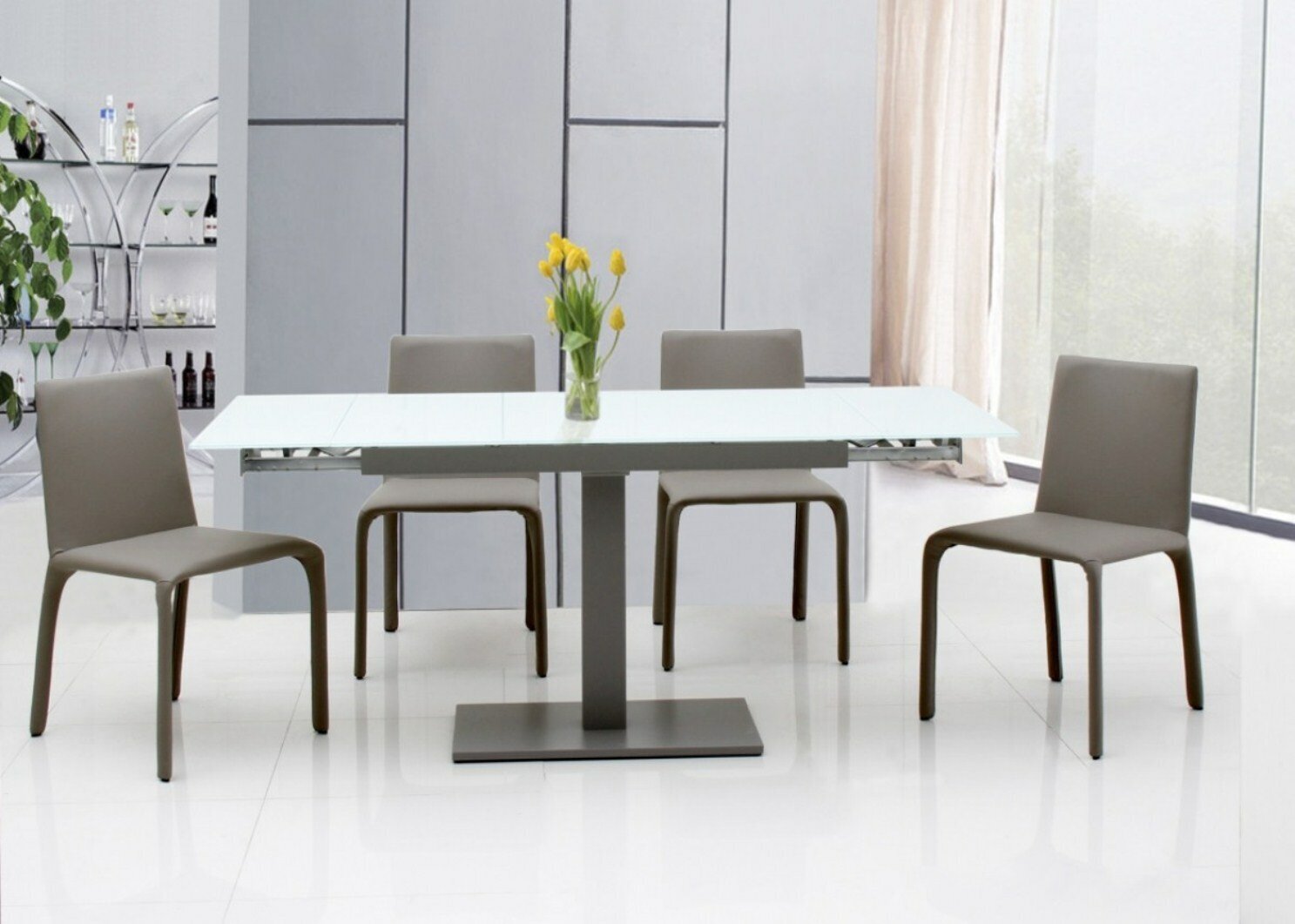A minimal pedestal table with hidden leaf