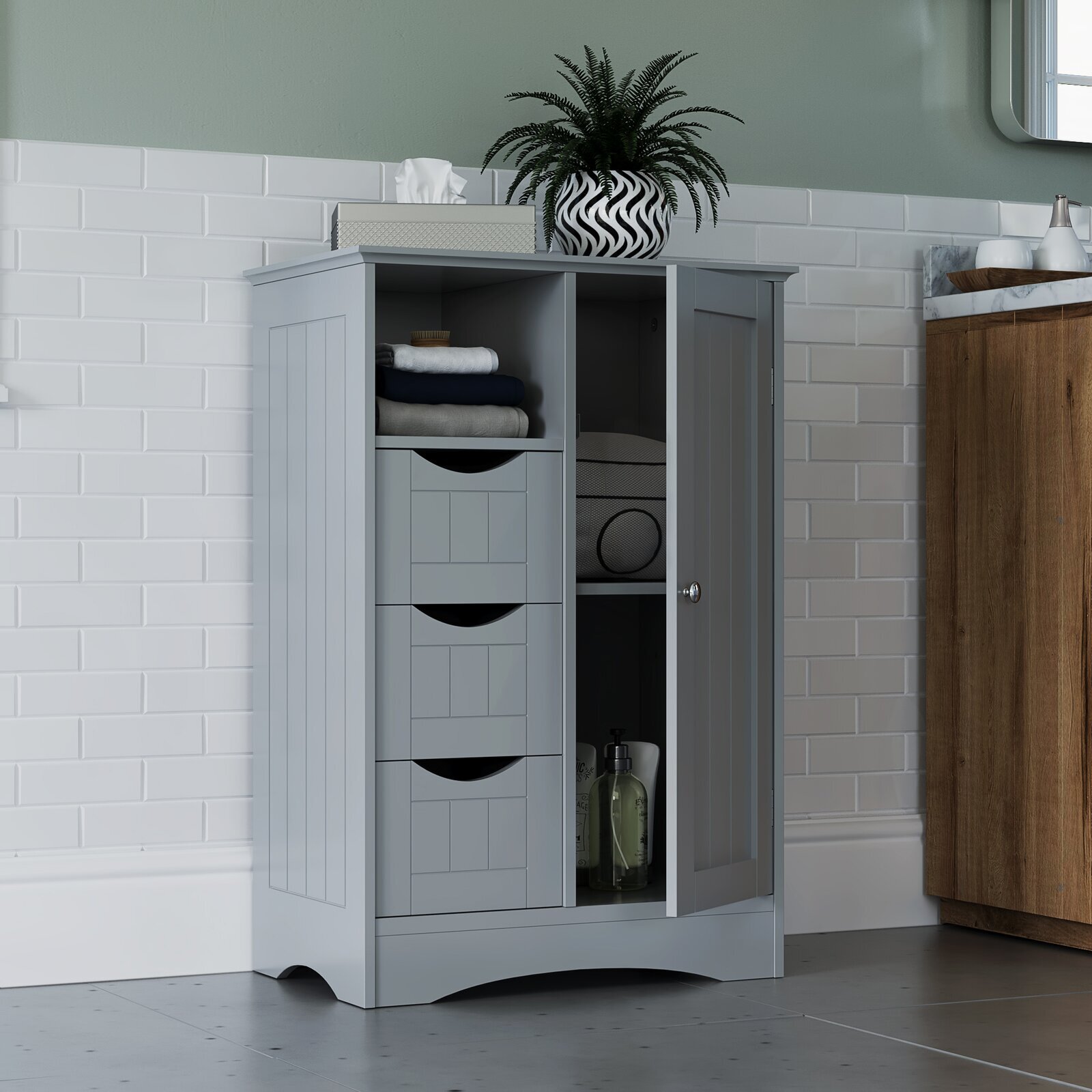 A shorter cabinet with drawers and tall shelving