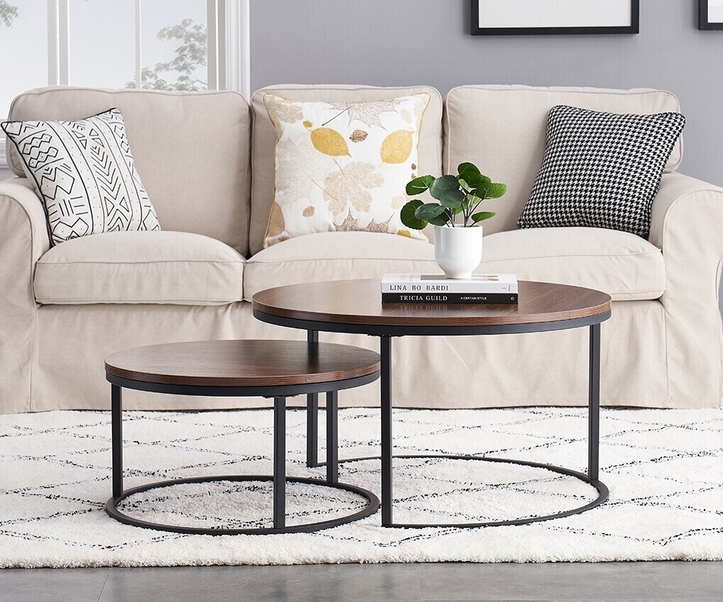 An extendable, nesting dark wood coffee table with black metal legs