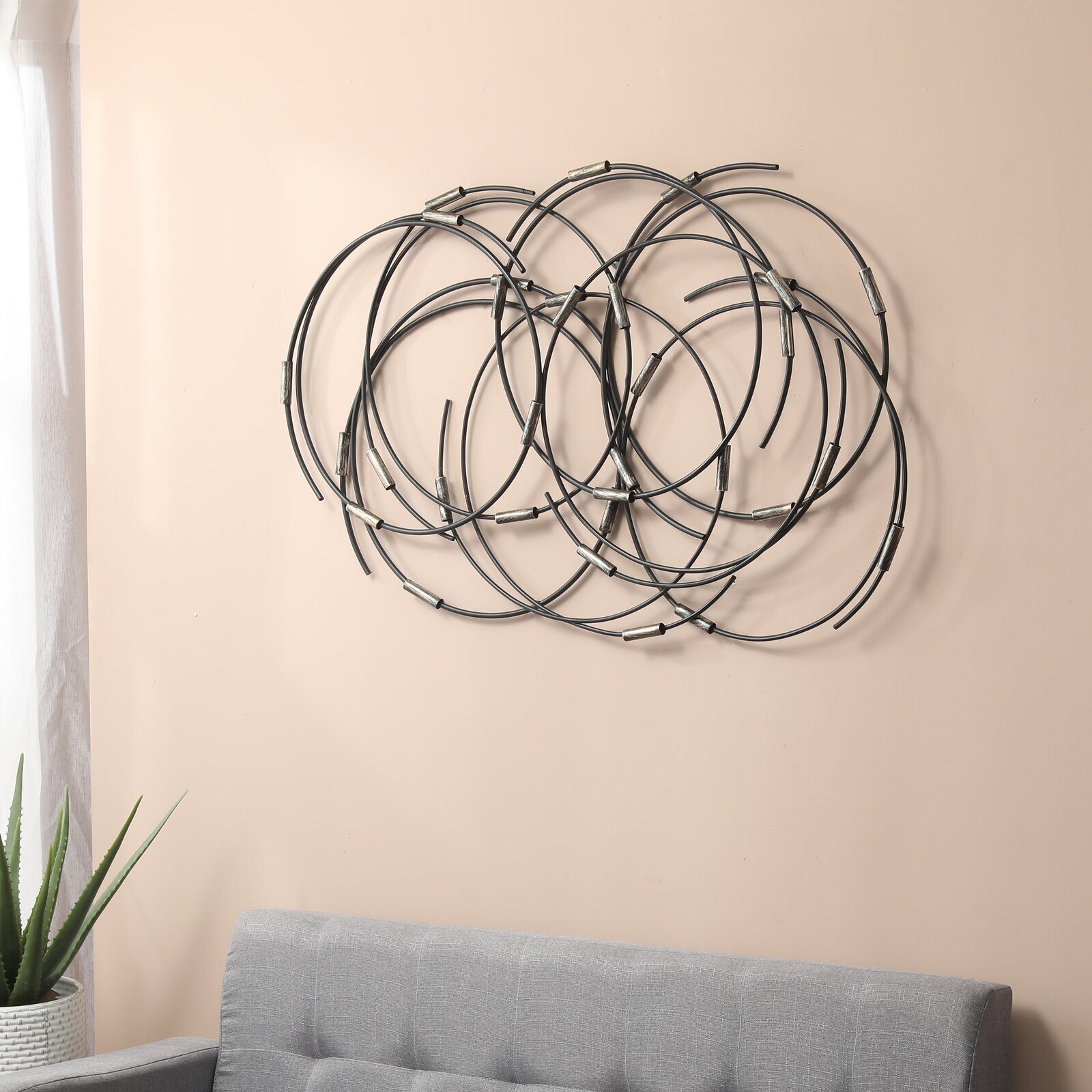 Circular abstract, messy wall art in a metal finish
