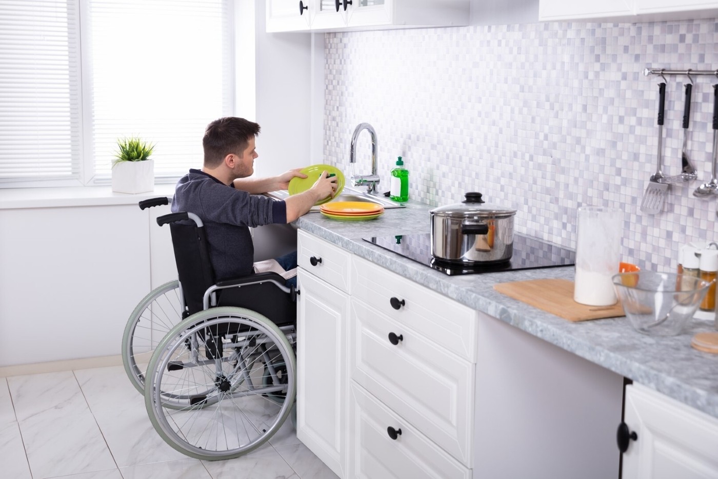 Man cleaning dishes in kitchen