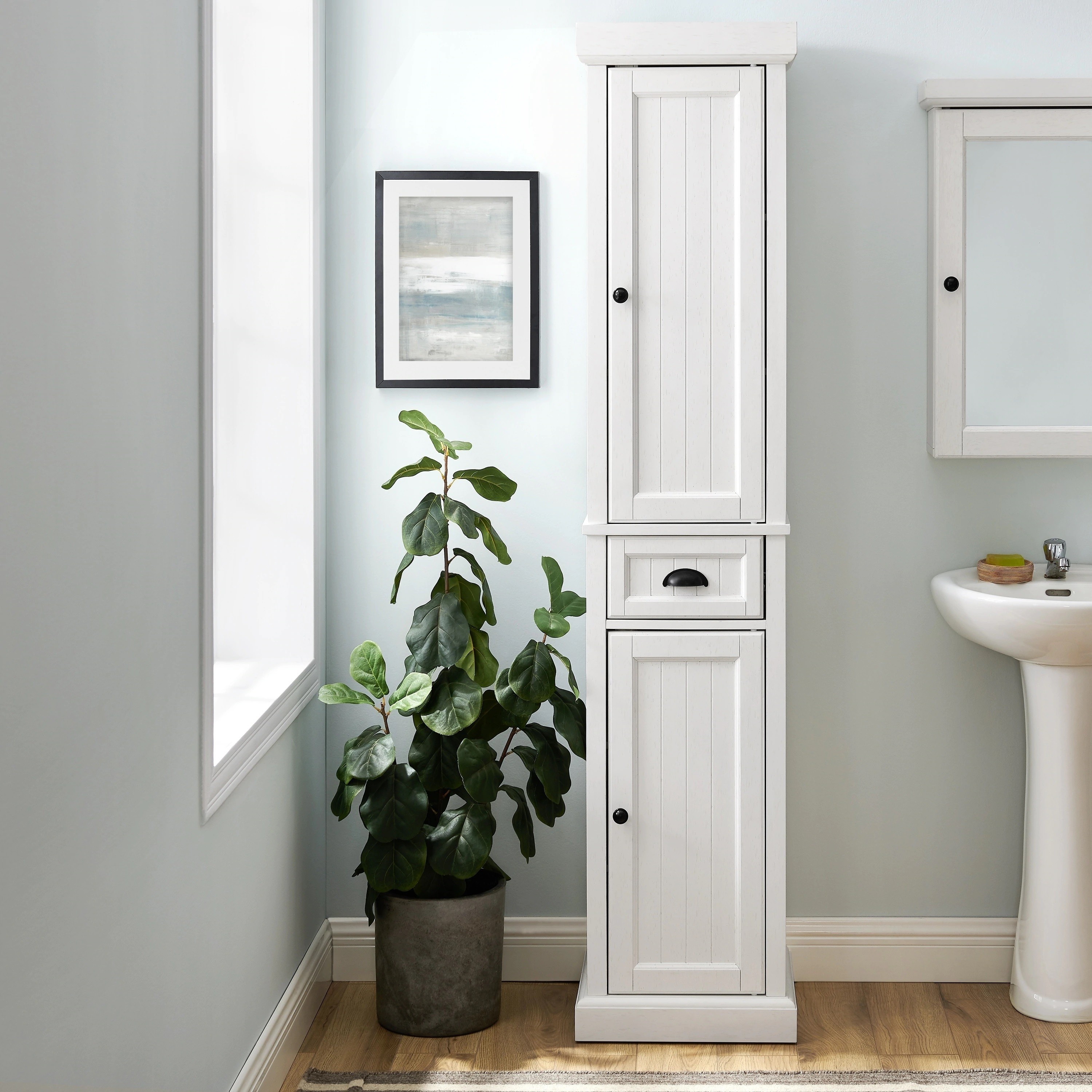 Nostalgic & decorative bathroom linen tower with a closed design