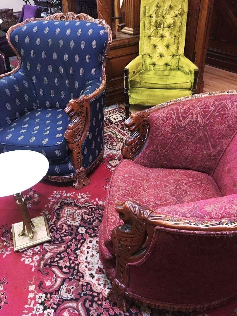 Victorian living room with eclectic furniture in many colours