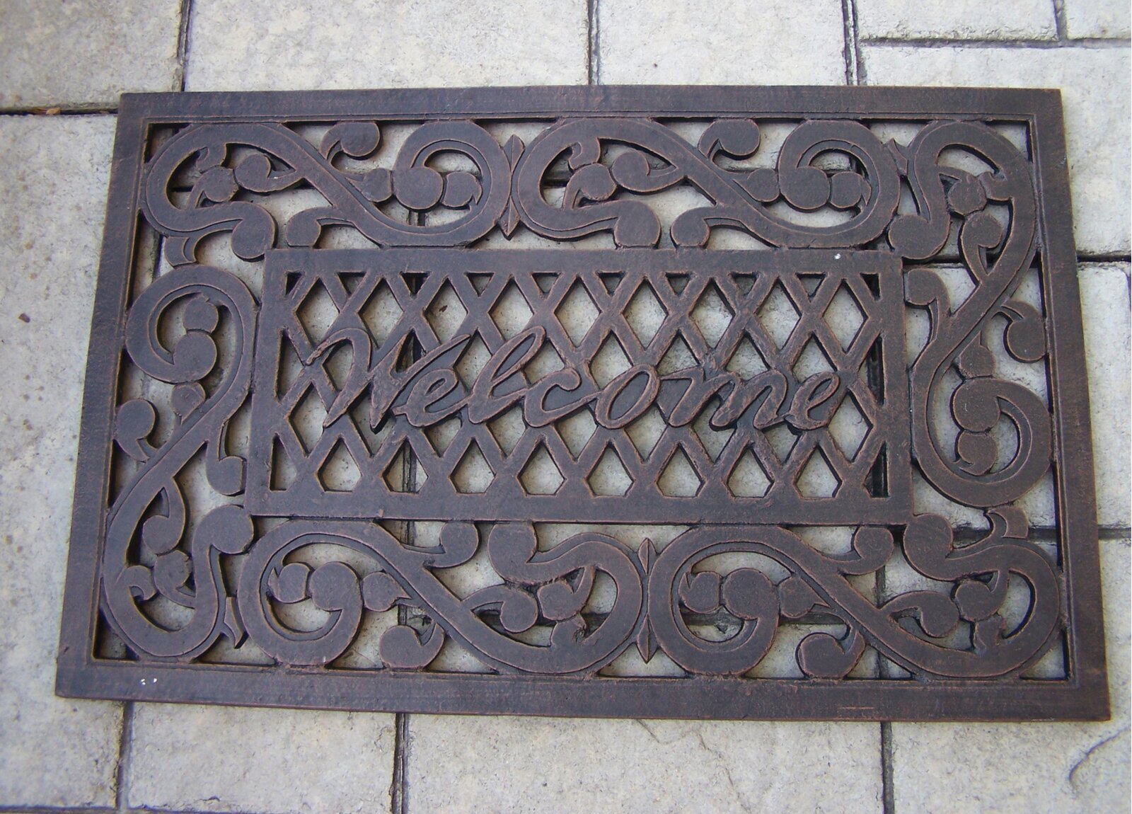 Metal door mat with a welcoming sign