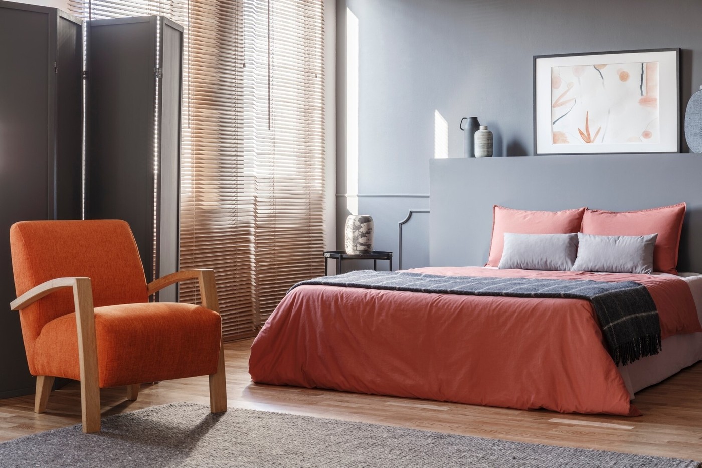 Orange armchair next to pink bed