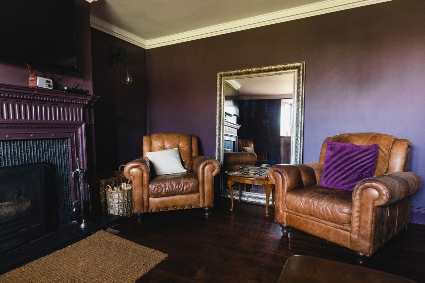 Two brown leather arm chairs