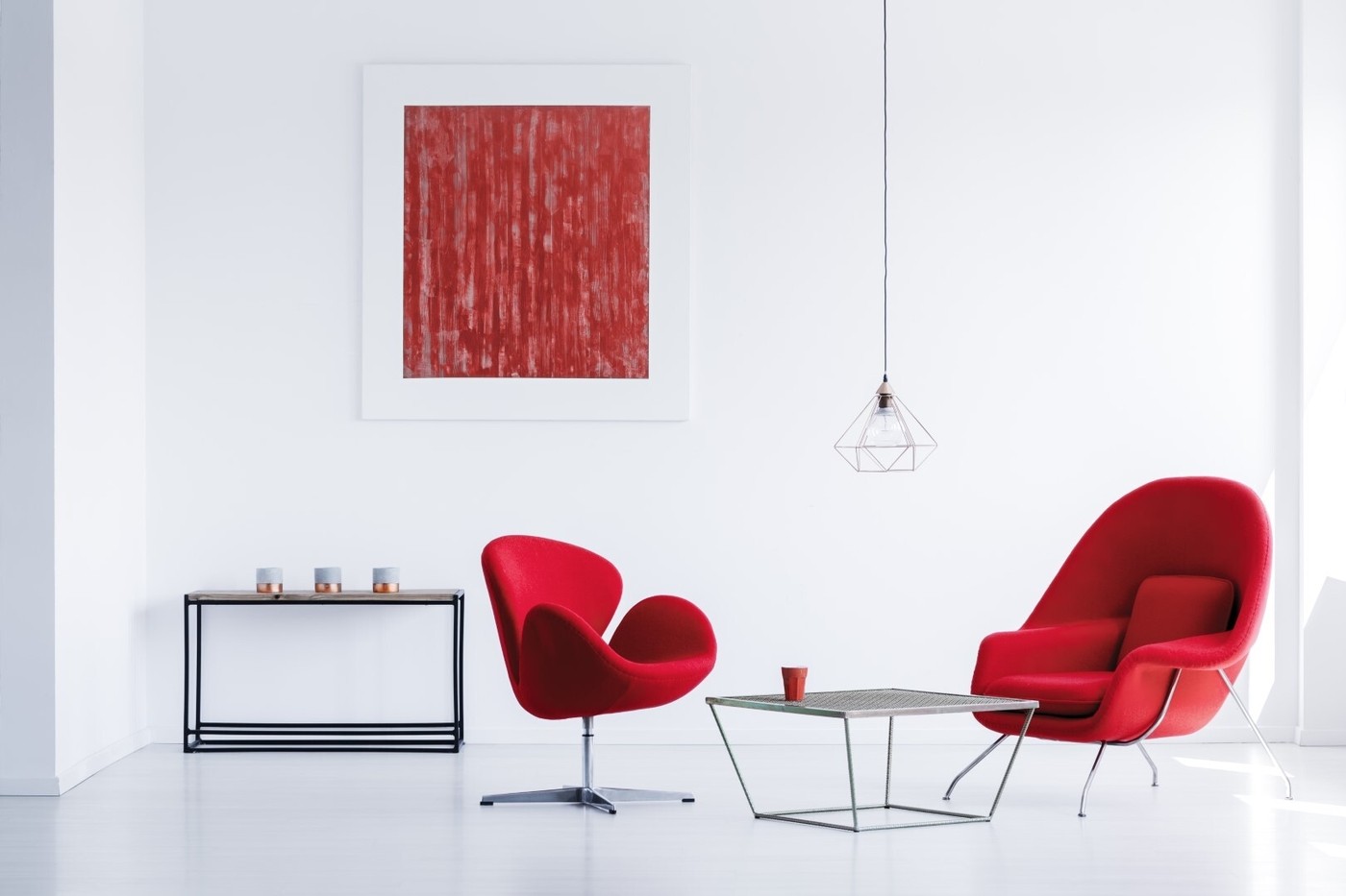White room with red armchairs