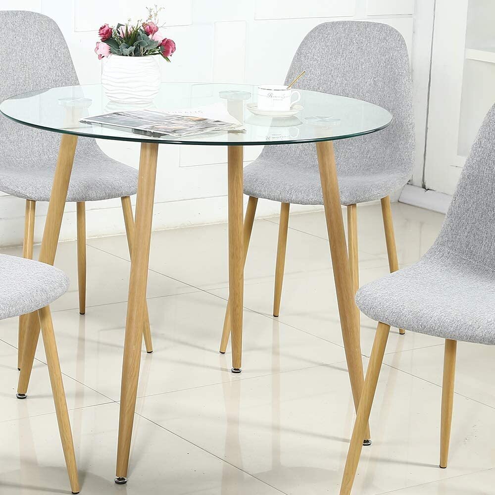 Glass Table With Gold Accented Legs And Ergonomic Chairs