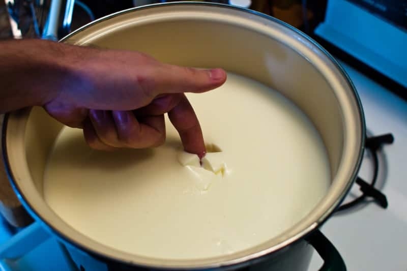 allowing the milk to curdle