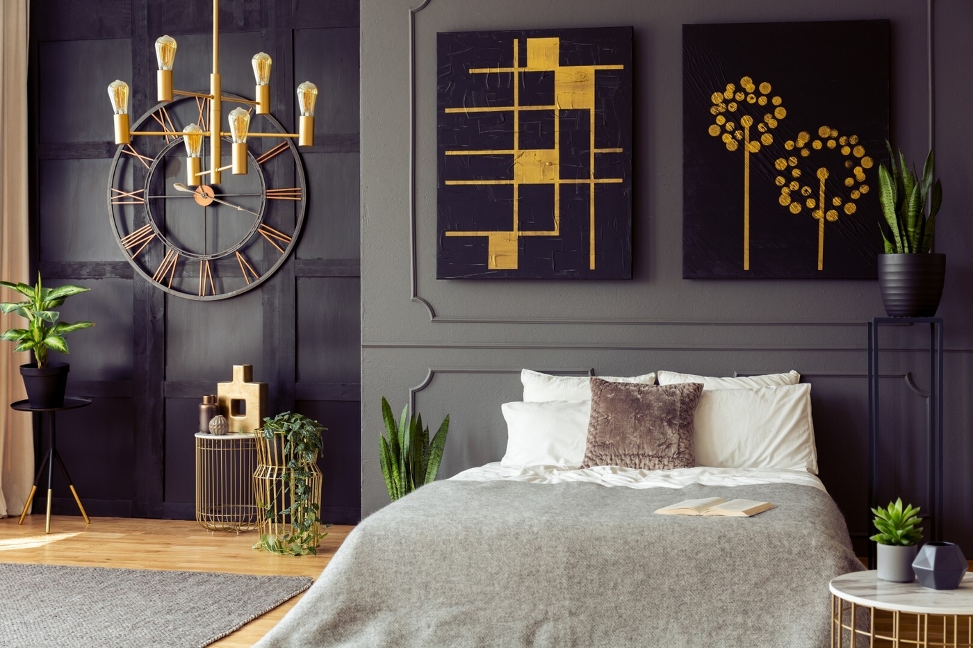Black and gold posters in grey bedroom