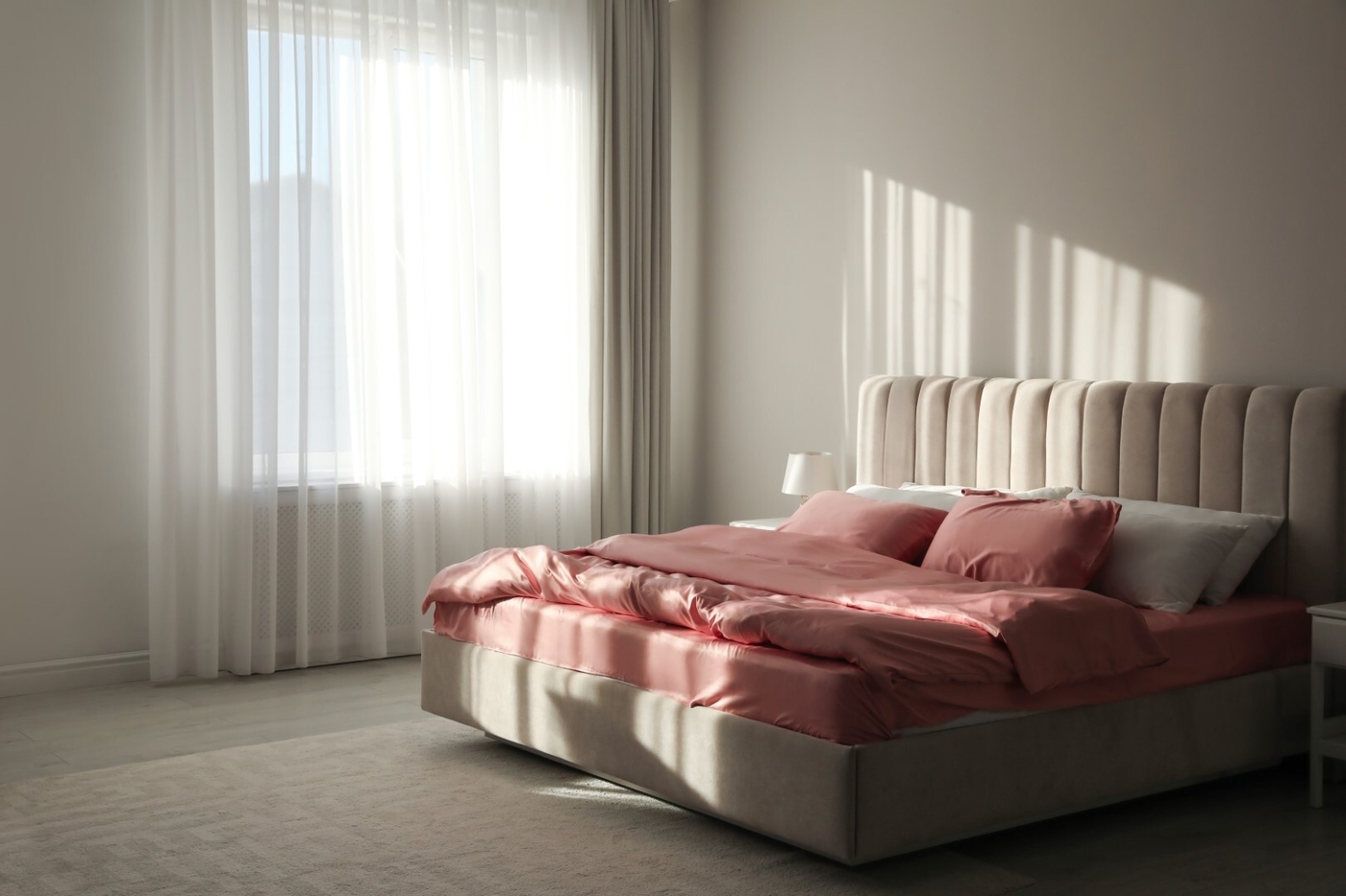 Comfortable bed with pink linens