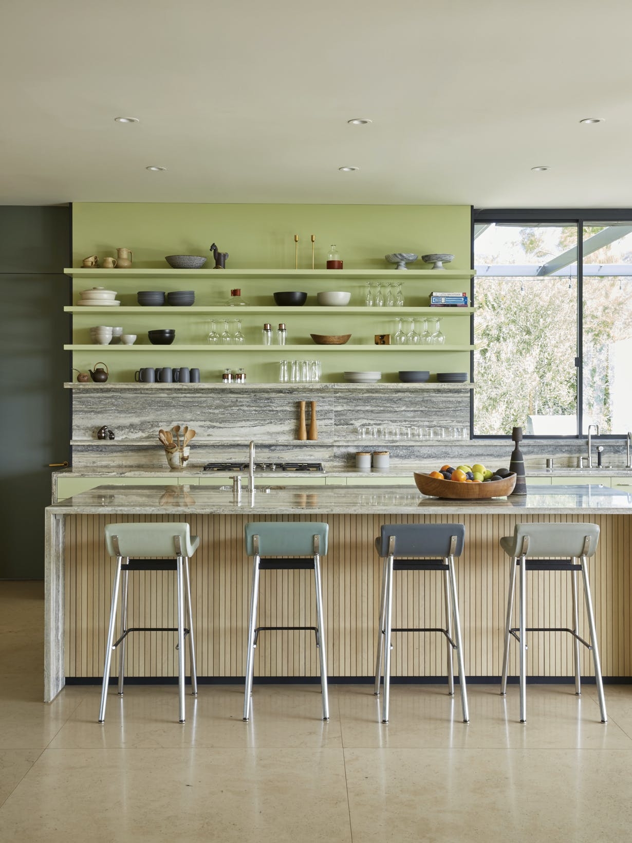 Green open kitchen shelving and wall