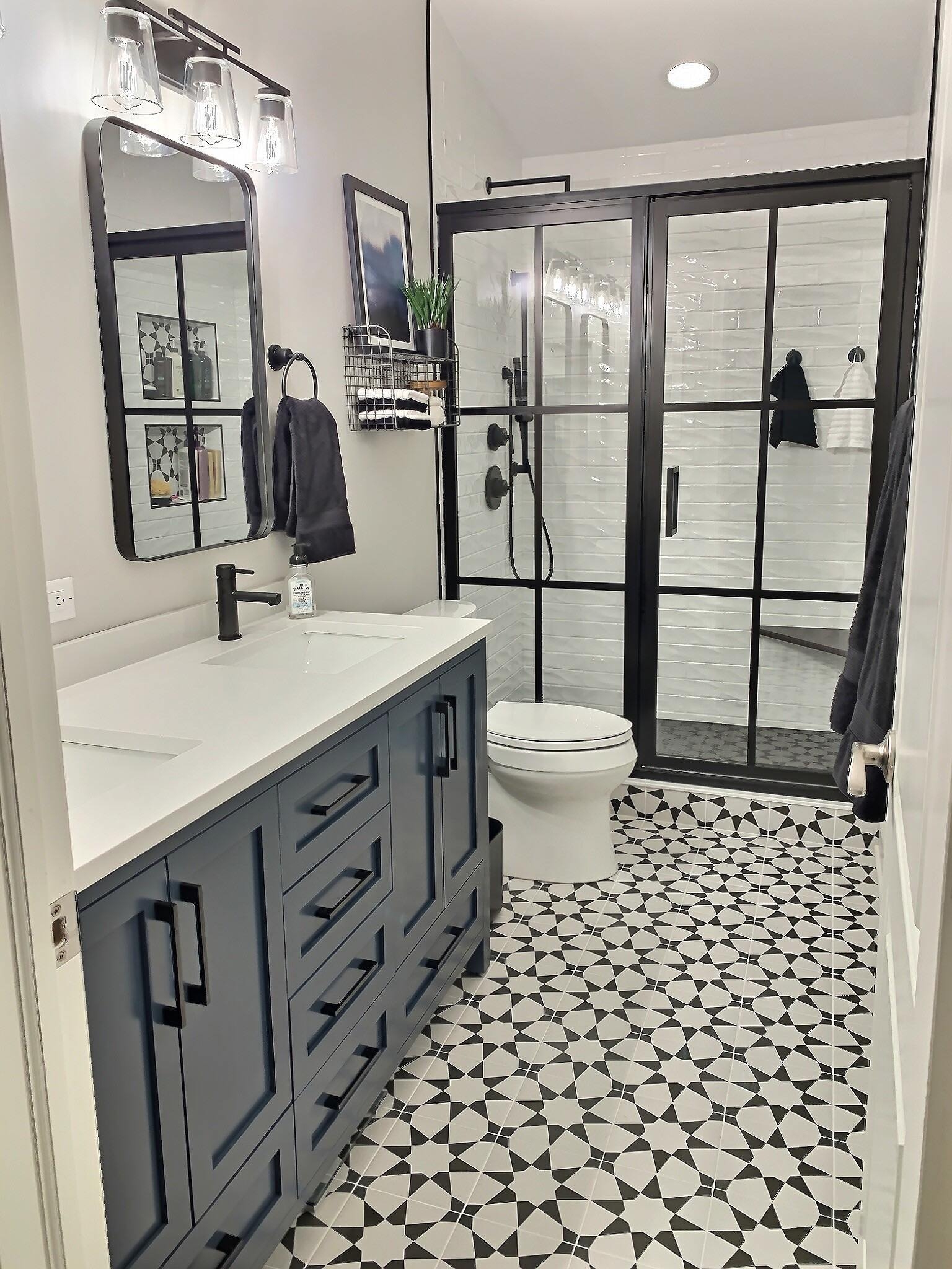 Industrial bathroom with black metal shower doors