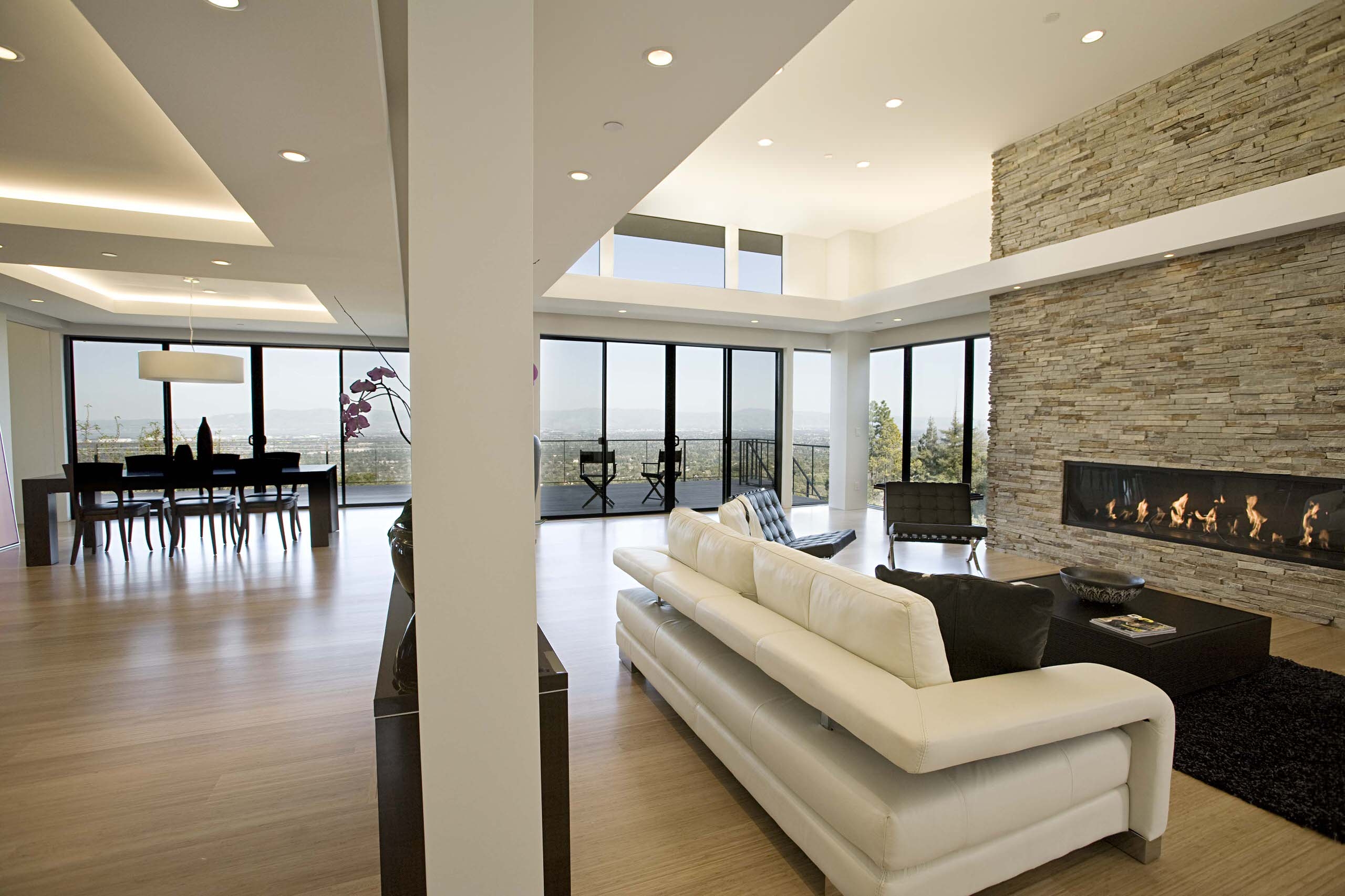 Large condo living space with stone fireplace wall