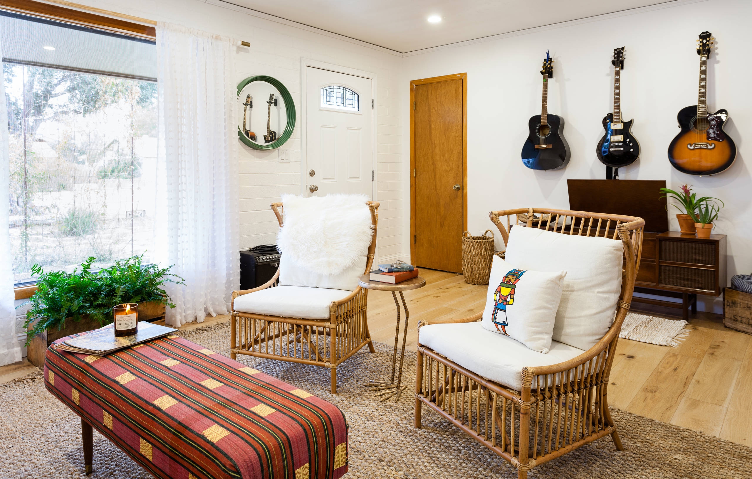 Minimalist bohemian living room with guitars on wall