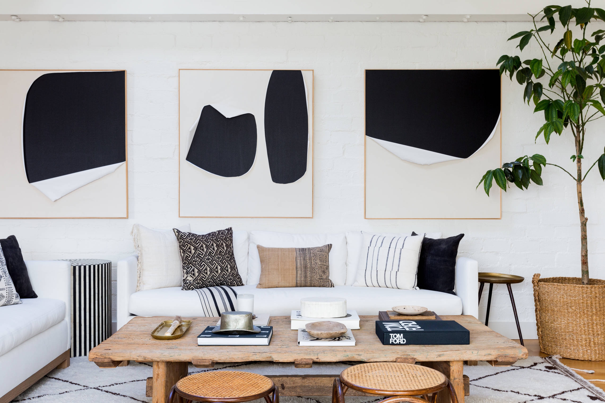 Modern living room with abstract art pieces on wall
