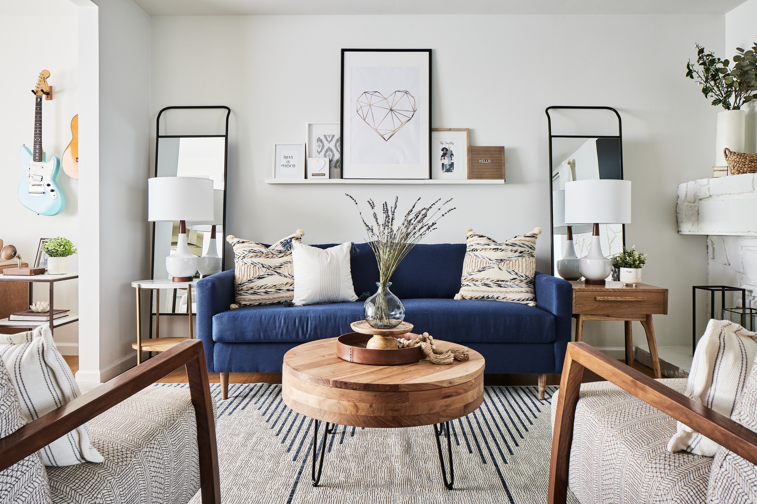 Modern living room with blue couch and double mirrors