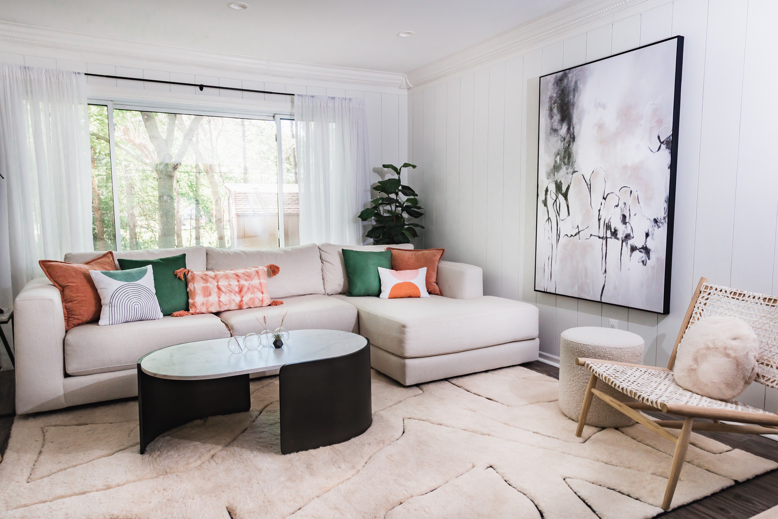 Modern living room with L-shaped sofa and white panelled walls