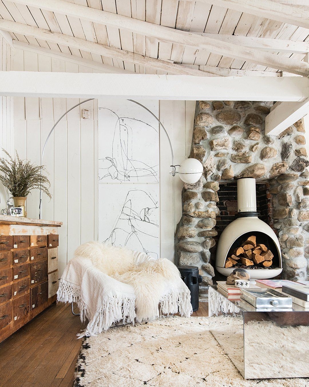 Modern living space with white-washed wood walls and ceiling