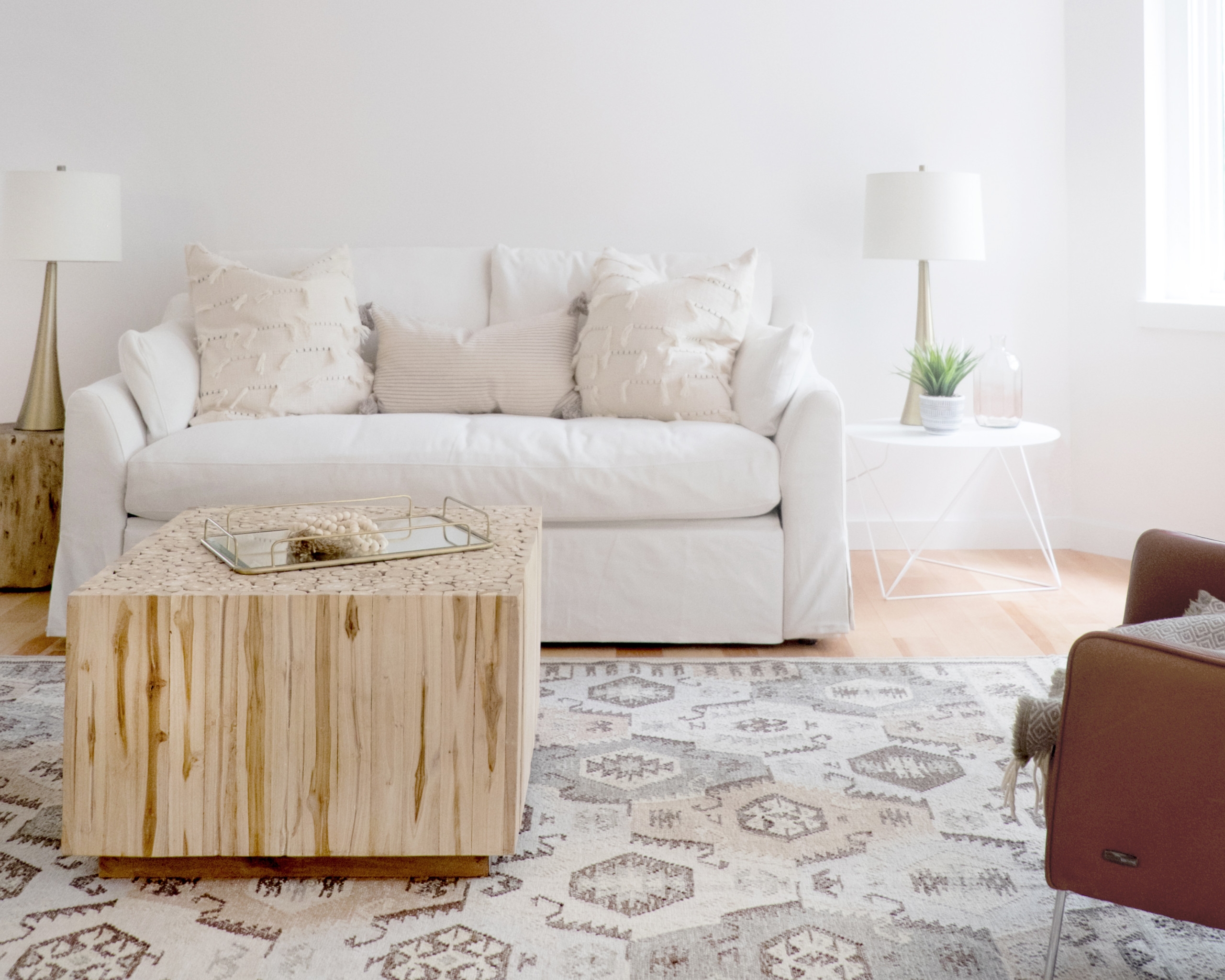 Neutral living space with patterned carpet and white couch