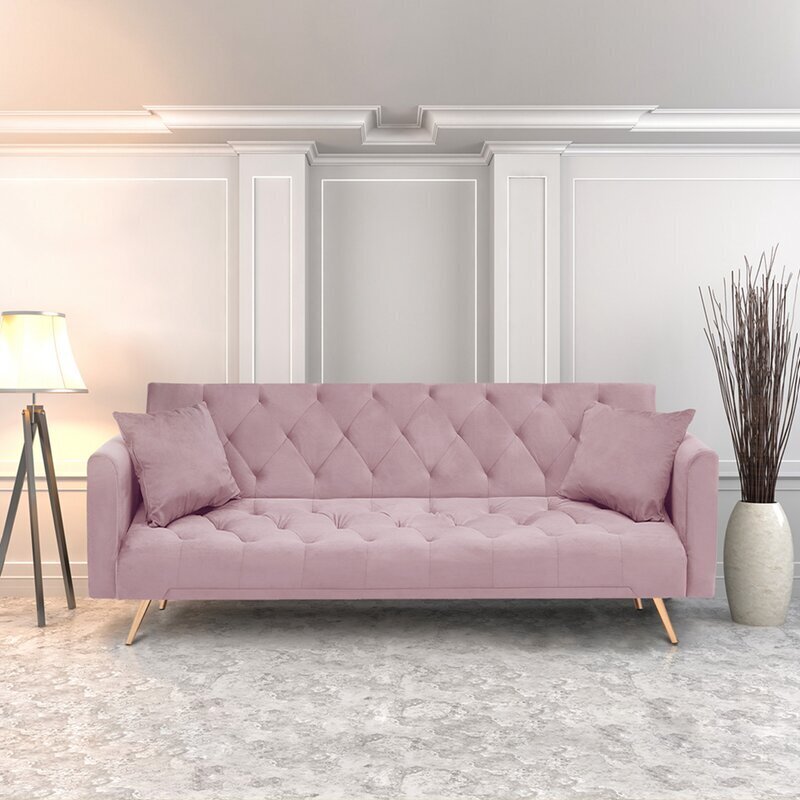 Pink tufted sofa with cushions