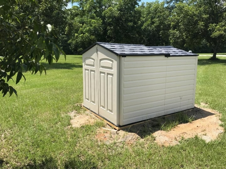 small garden shed covering a well