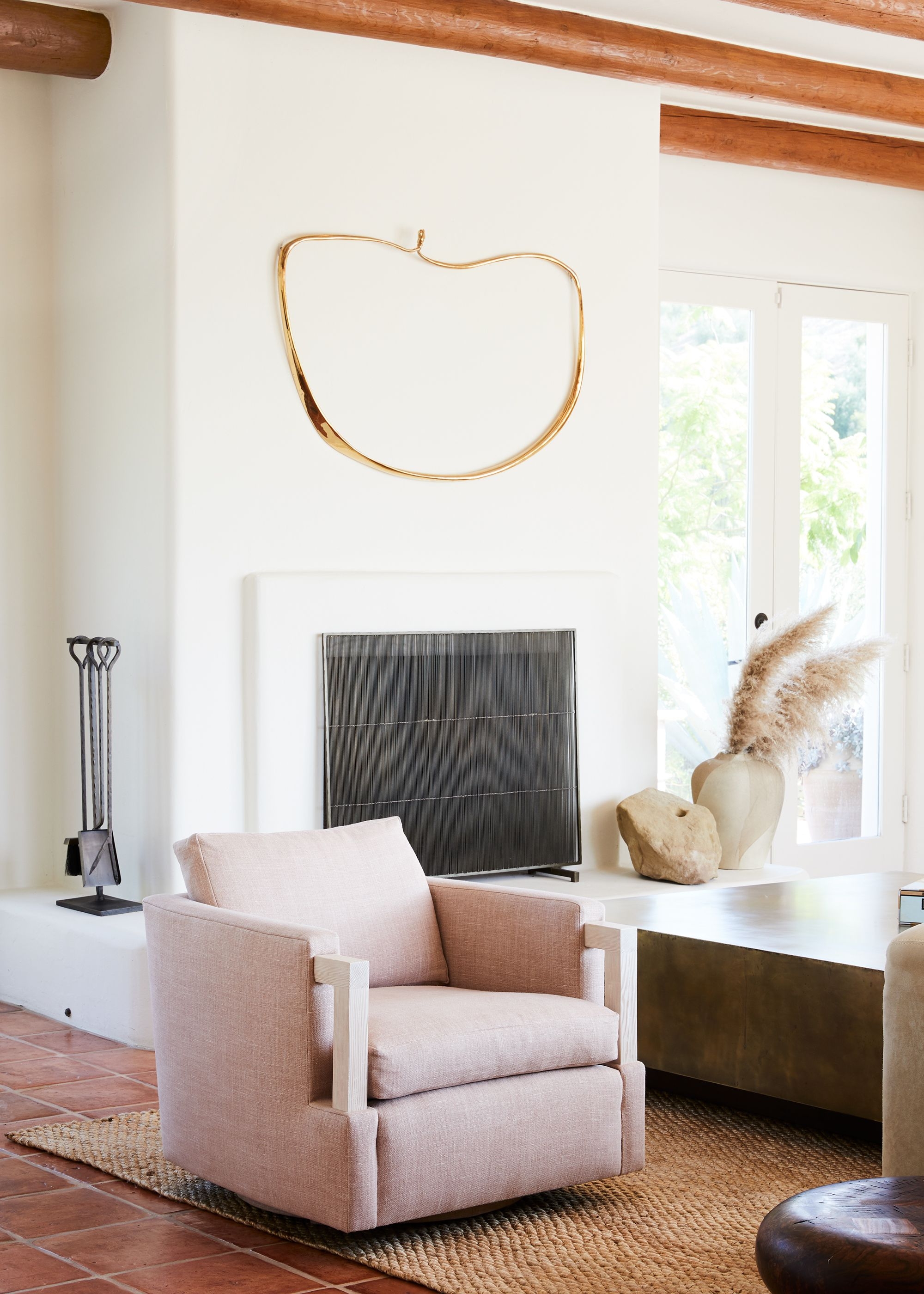 Small minimalist living space with creamy white fireplace