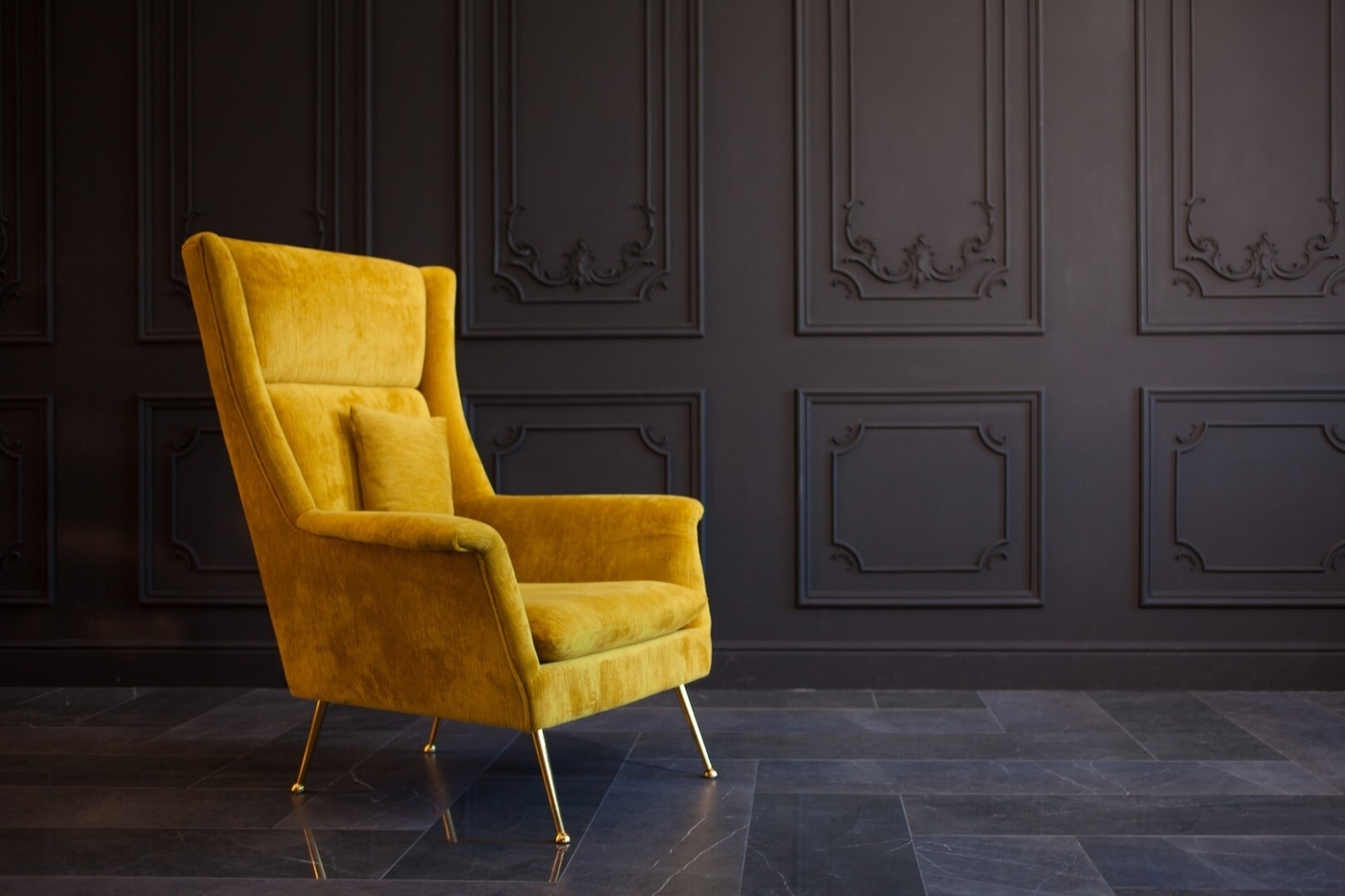 Stylish chair against a dark gray wall