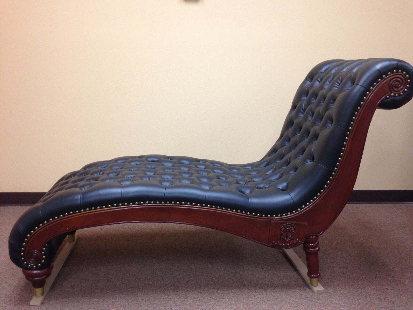 Tufted black leather chaise lounge