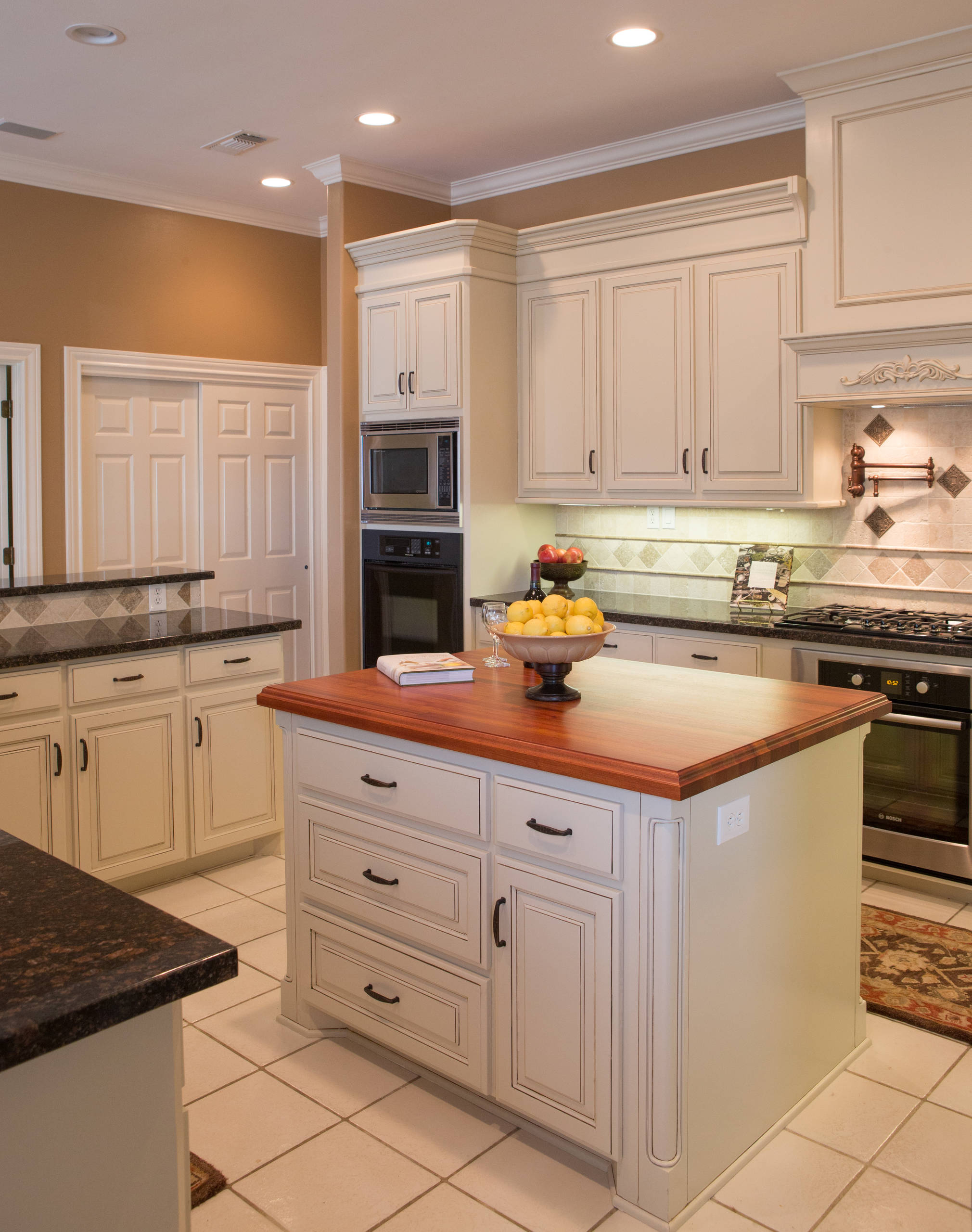 White kitchen island with a wooden top