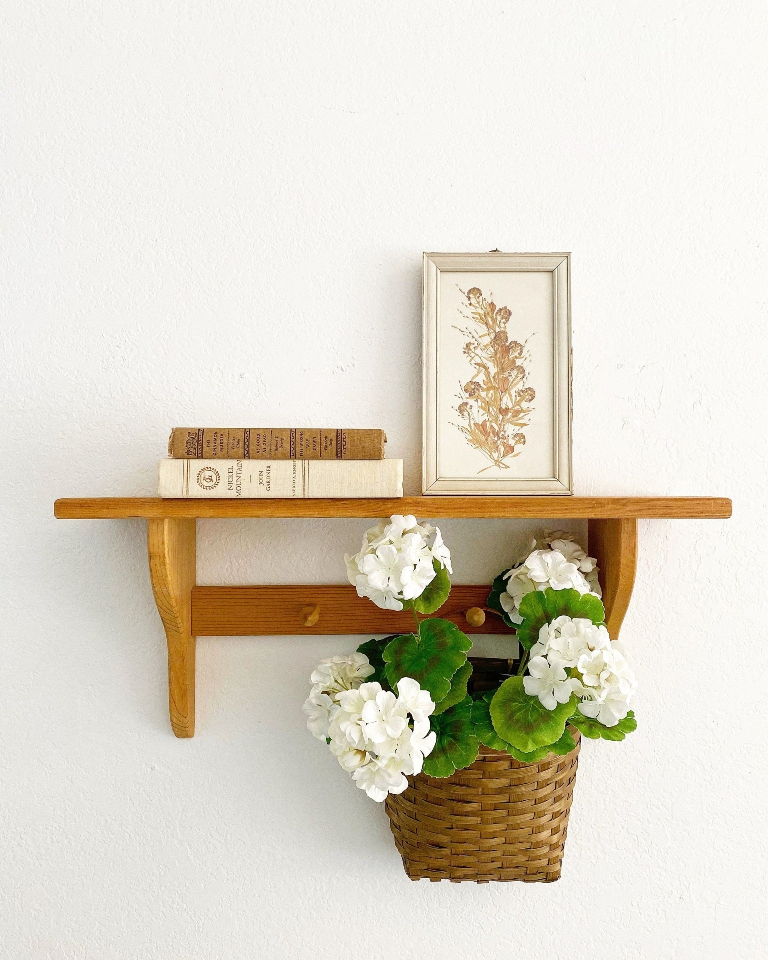 Wood wall shelf with two peg hooks
