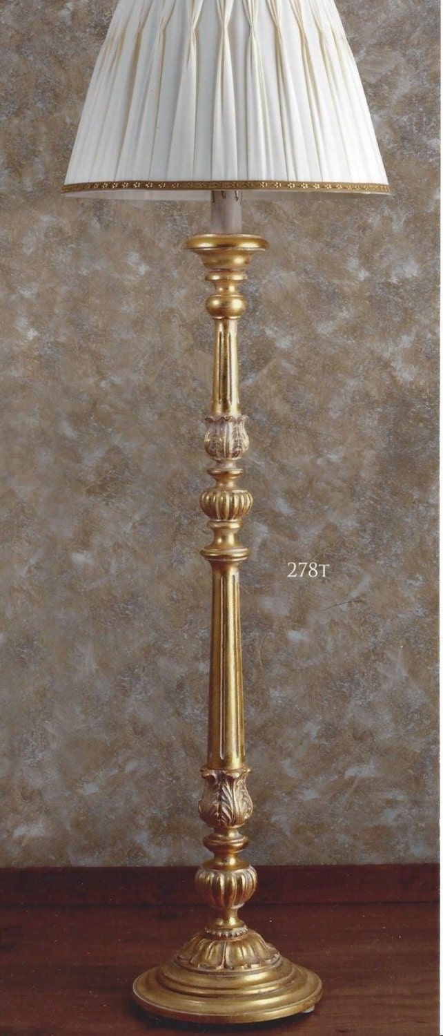 Wooden floor lamp with details in wood paste, decorated in pinstriped gold leaf with lampshade