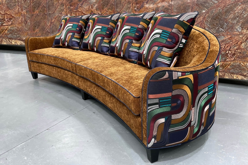 Art Deco Parisian Curved Sofa with Bold Patterned Cushions