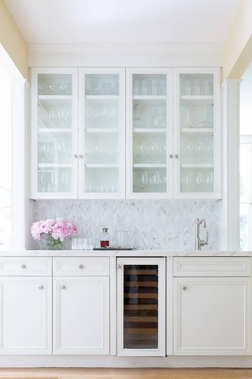 Beautiful white wet bar features glass front white cabinets mounted ...
