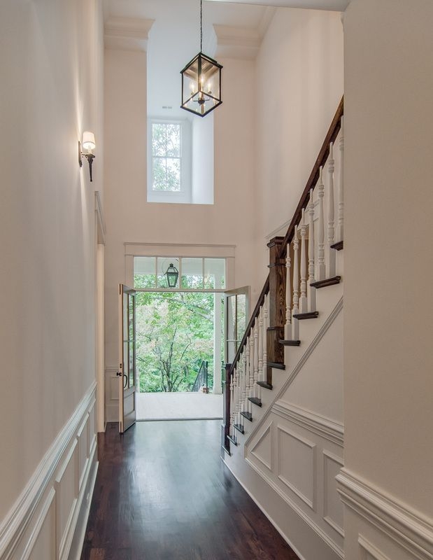 Bright Two-Story Foyer with Modern Lighting